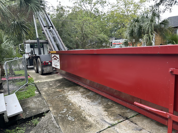 red dumpster parked in driveway